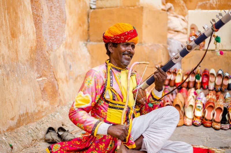 4 Days Rajasthan Tour Packages - A man in traditional clothing playing a musical instrument