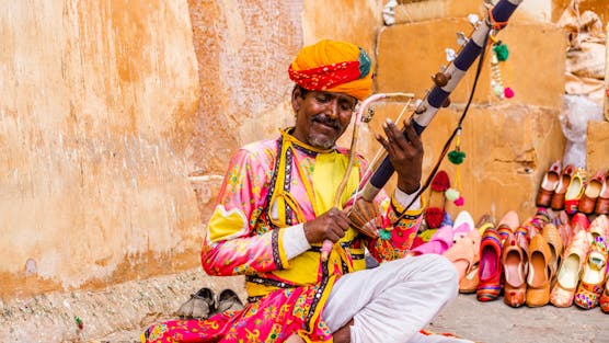 Jaipur Same Day Tour from Delhi by Car - Man Play Instrument in City Palace